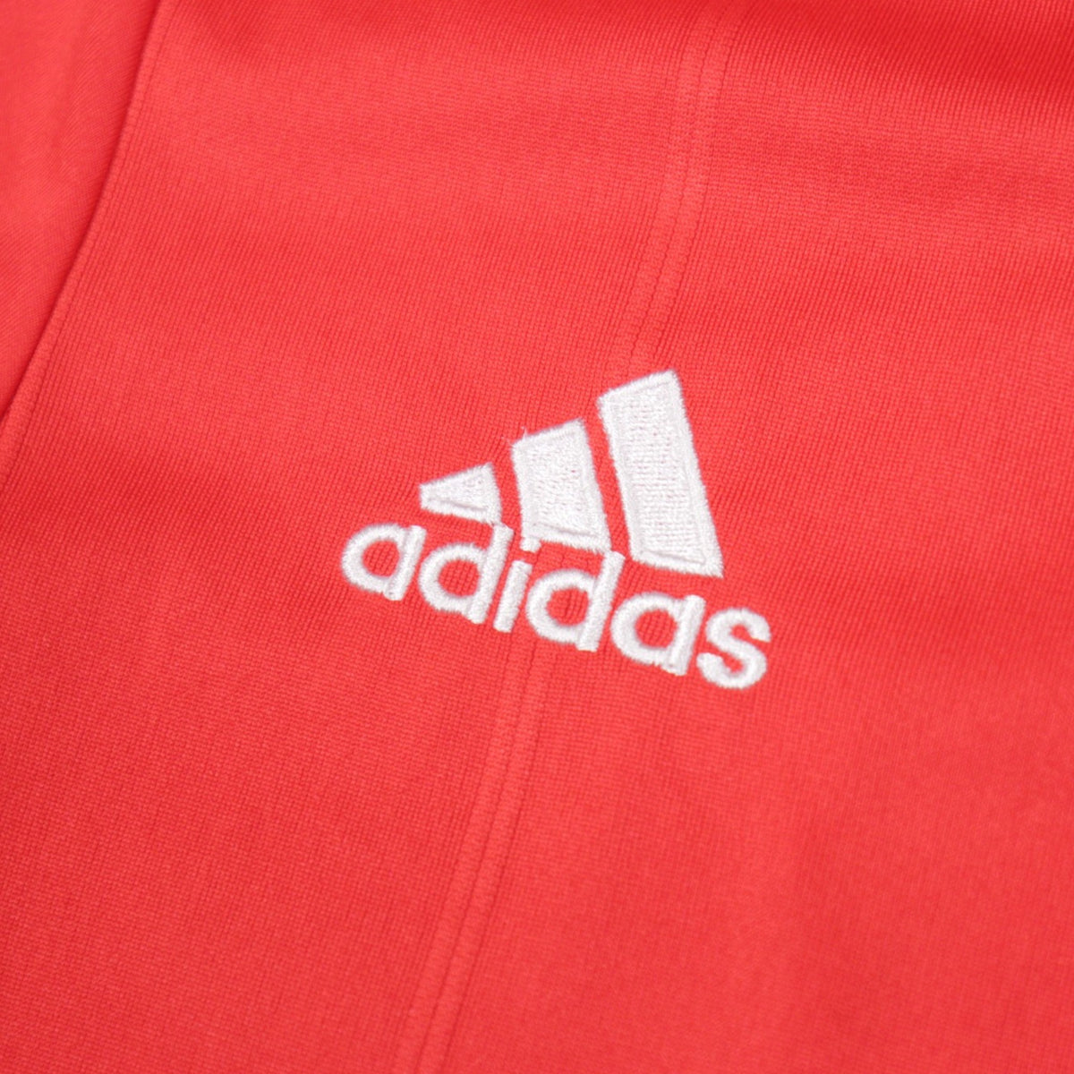 Close-up of the adidas logo embroidered on the shirt