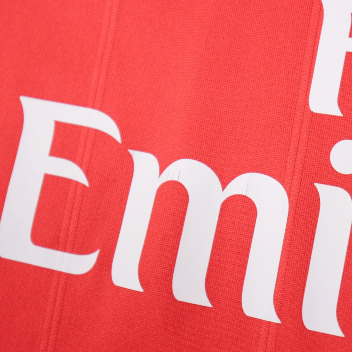 Close-up of the Fly Emirates sponsor print on the shirt
