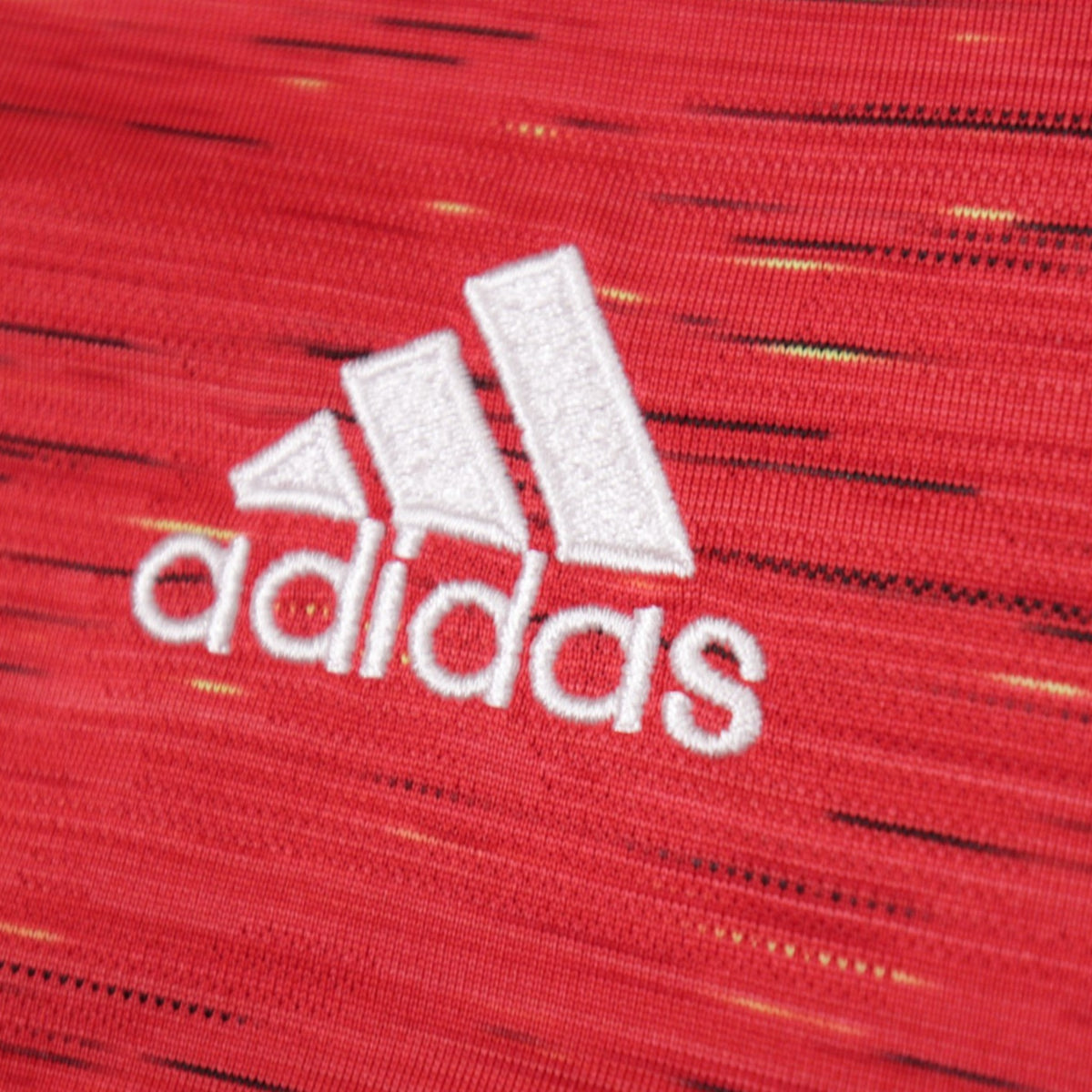 Close-up of adidas logo on Manchester United shirt fabric