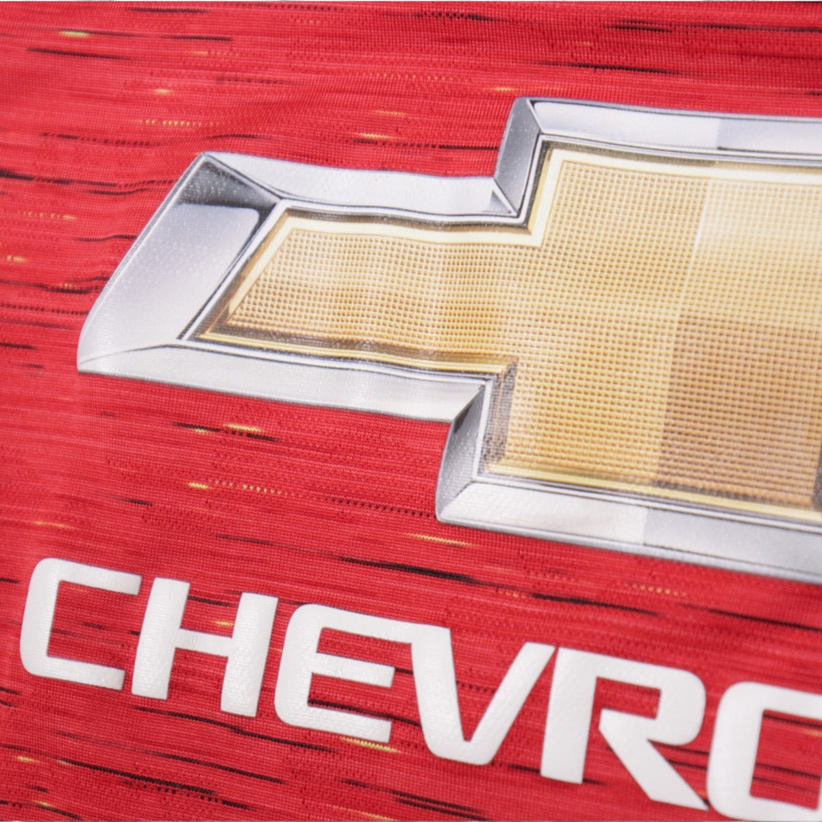 Close-up of Chevrolet sponsor and crest detail on Manchester United shirt