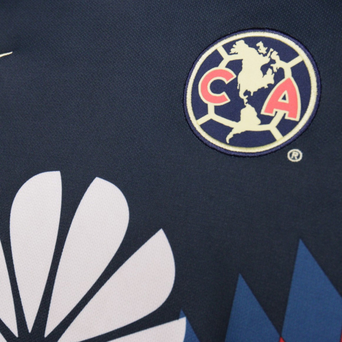 Detail of the América club crest on the front of the shirt