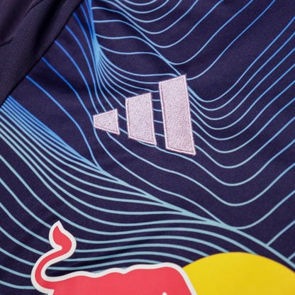 Close-up of adidas logo and blue wave print on the shirt fabric