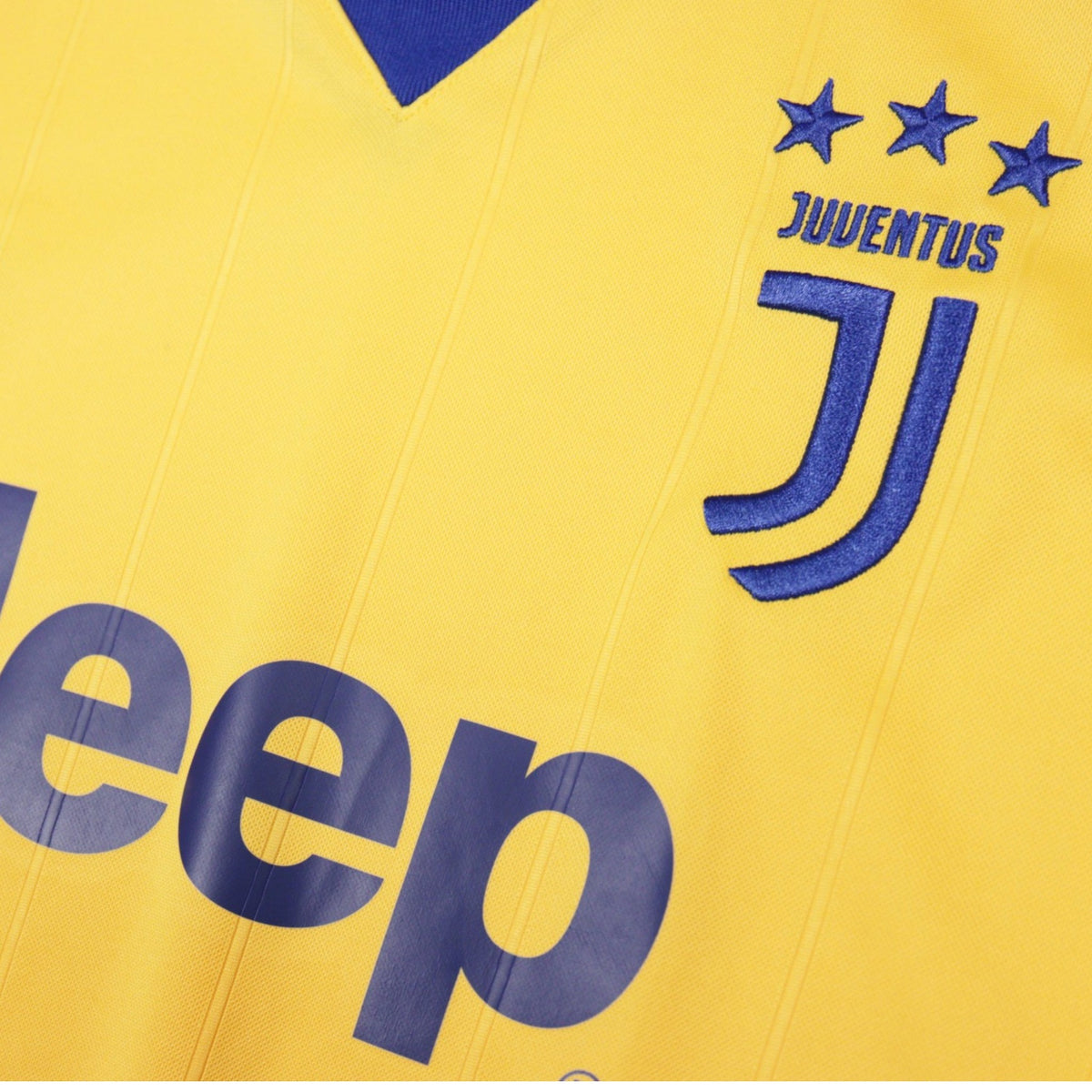 Close-up of Juventus crest and Jeep sponsor on yellow away shirt