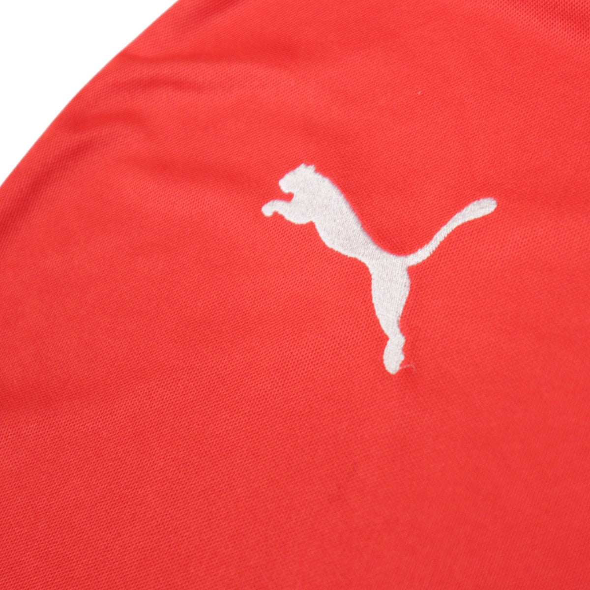 Close-up of the Puma logo on the sleeve of the 2014/15 Arsenal home shirt
