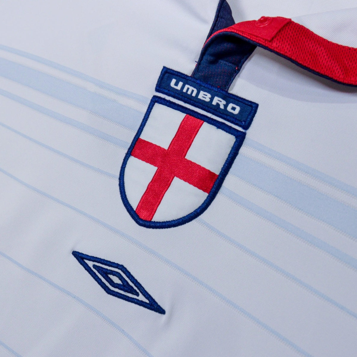 Close-up of England crest with Umbro tab and diamond logo on the chest