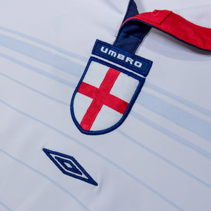 Close-up of England crest with Umbro tab and diamond logo on the chest