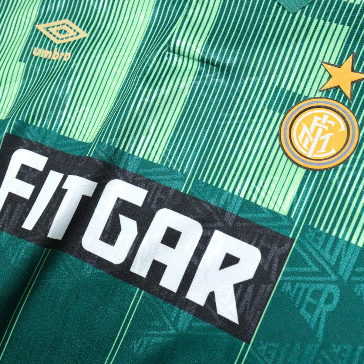 Close-up of Umbro logo, crest and FitGar sponsor on the chest