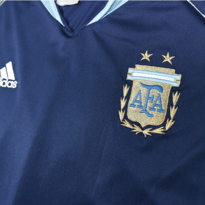 Close-up of adidas logo and AFA crest with two stars on the chest