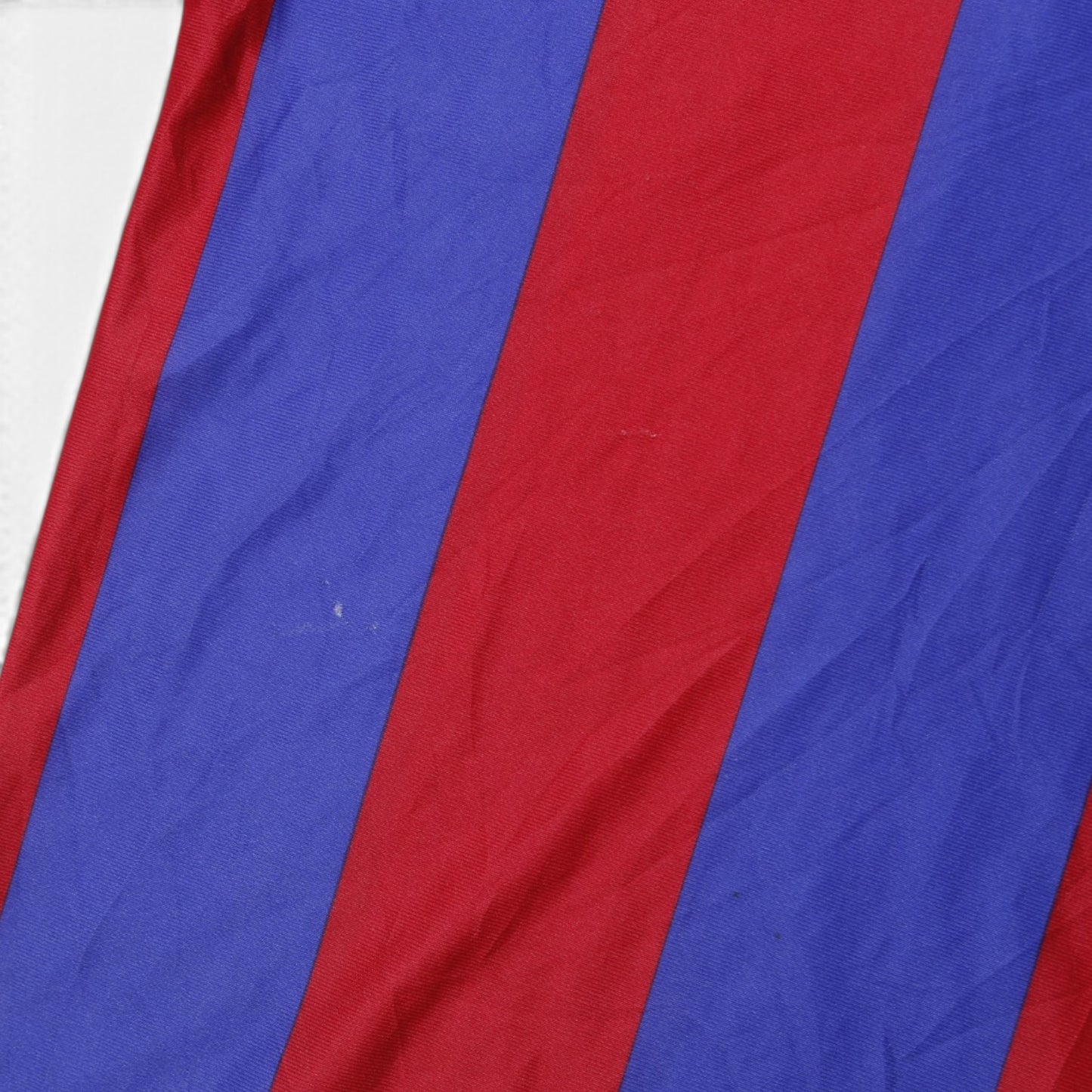 Close-up of blue and claret striped fabric on Barcelona shirt