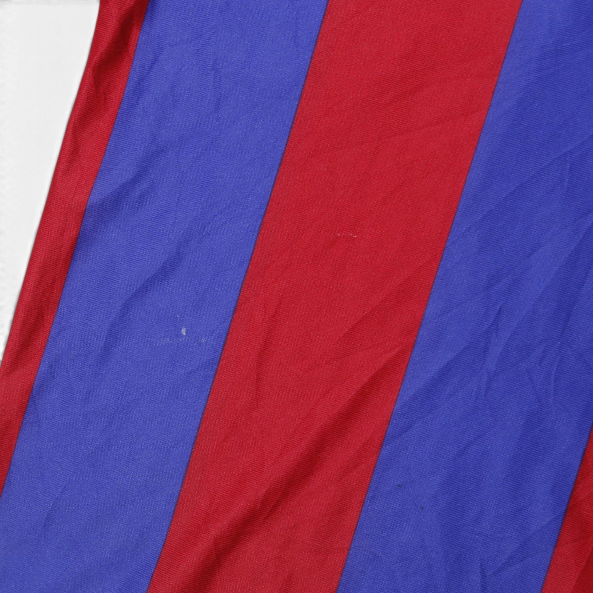 Close-up of blue and claret striped fabric on Barcelona shirt