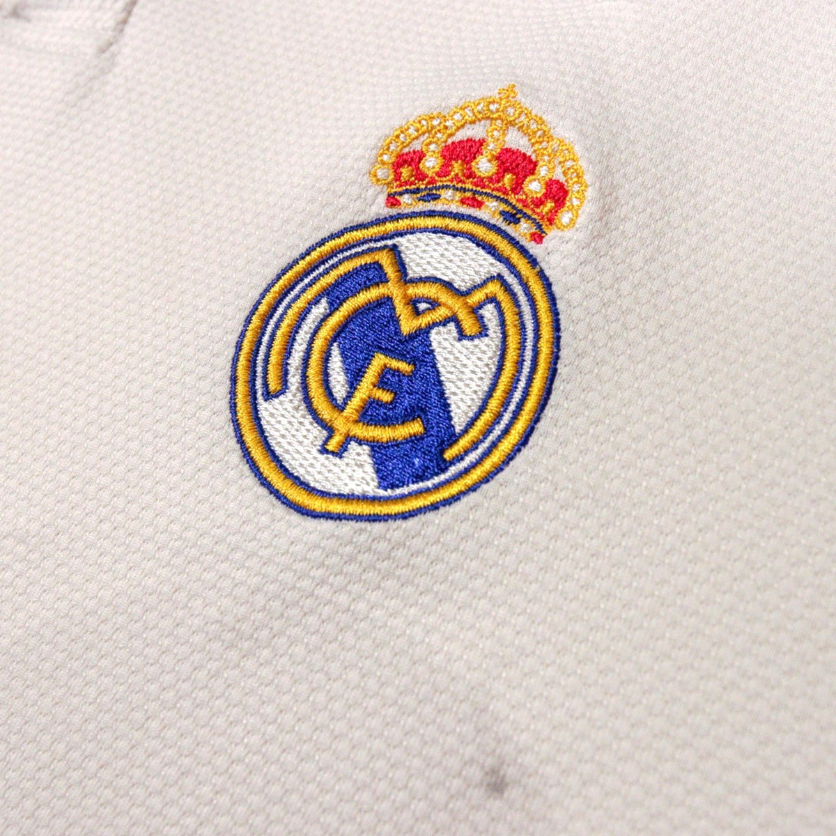 Close-up of Real Madrid crest on shirt chest
