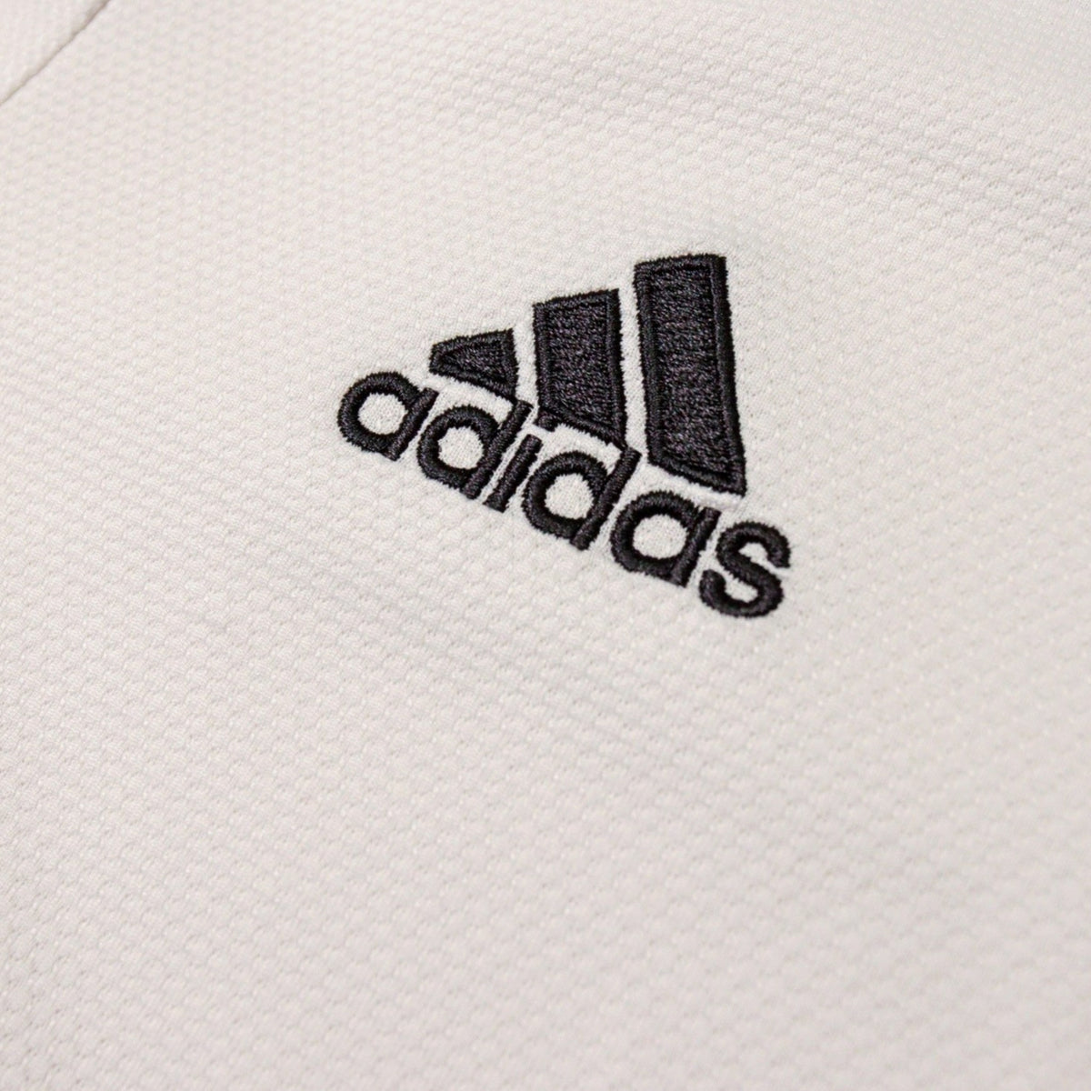 Close-up of adidas logo on Real Madrid shirt chest