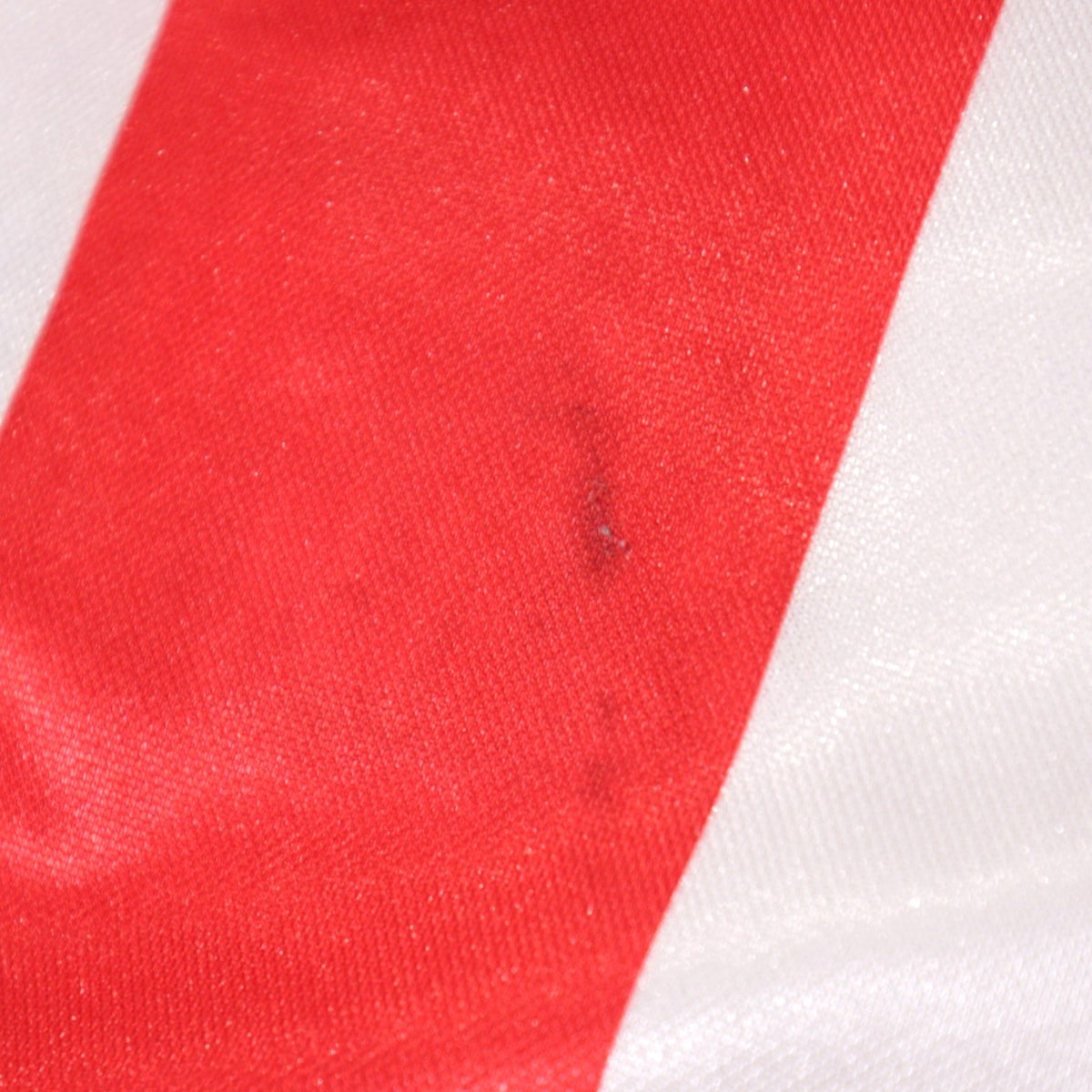 Close-up detail of a small mark on the red stripe fabric