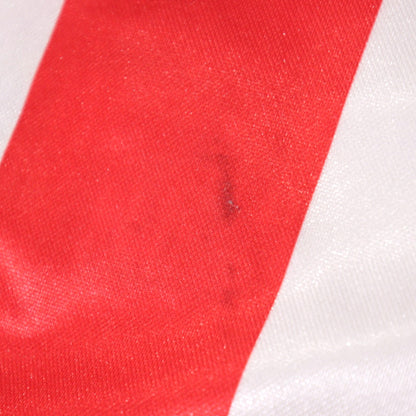 Close-up detail of a small mark on the red stripe fabric