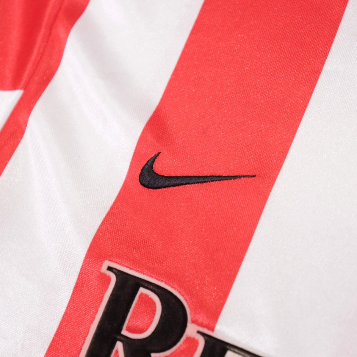 Close-up of the Nike swoosh embroidered on the chest stripe