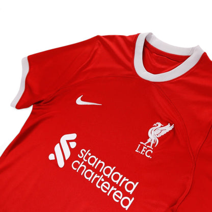 Close-up of the Nike swoosh, Liverpool crest and Standard Chartered sponsor on the chest