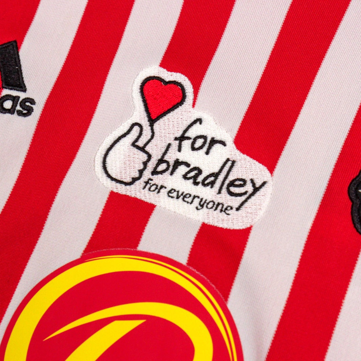 Close-up of the 'for bradley' charity patch on the home shirt
