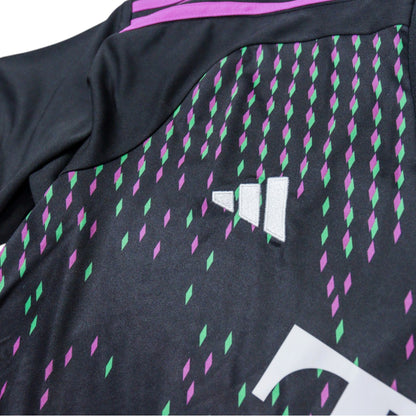 Close-up of adidas logo and diamond pattern on the shoulder area