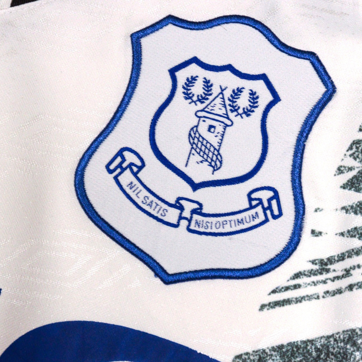 Close-up of embroidered Everton crest on shirt