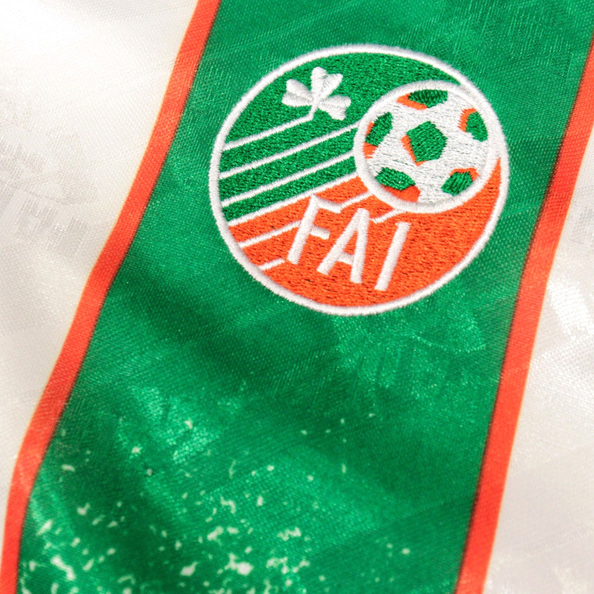 Close-up of FAI crest embroidered on the chest of the Republic of Ireland away shirt