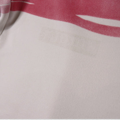 Close-up of a faint mark on the white fabric below the pink stripe
