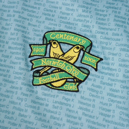 Close-up of embroidered Norwich City centenary crest with two canaries and 1902-2002 banners