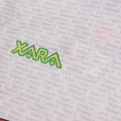 Close-up of Xara logo printed on the shirt alongside the repeating supporters' surname pattern