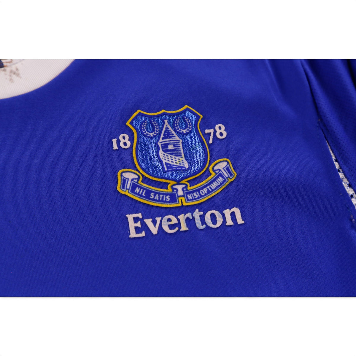 Close-up of Everton crest detail on blue shirt fabric