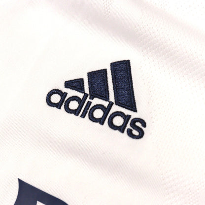 Close-up of adidas logo on chest