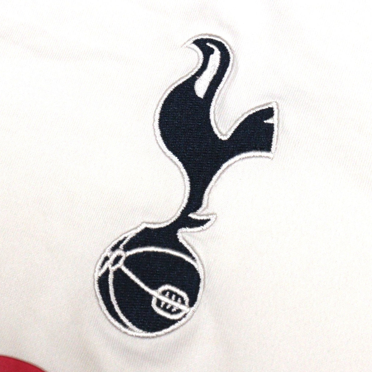 Close-up of the embroidered Tottenham cockerel-on-ball crest