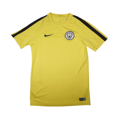 Manchester City yellow Nike training shirt front view with crest and swoosh