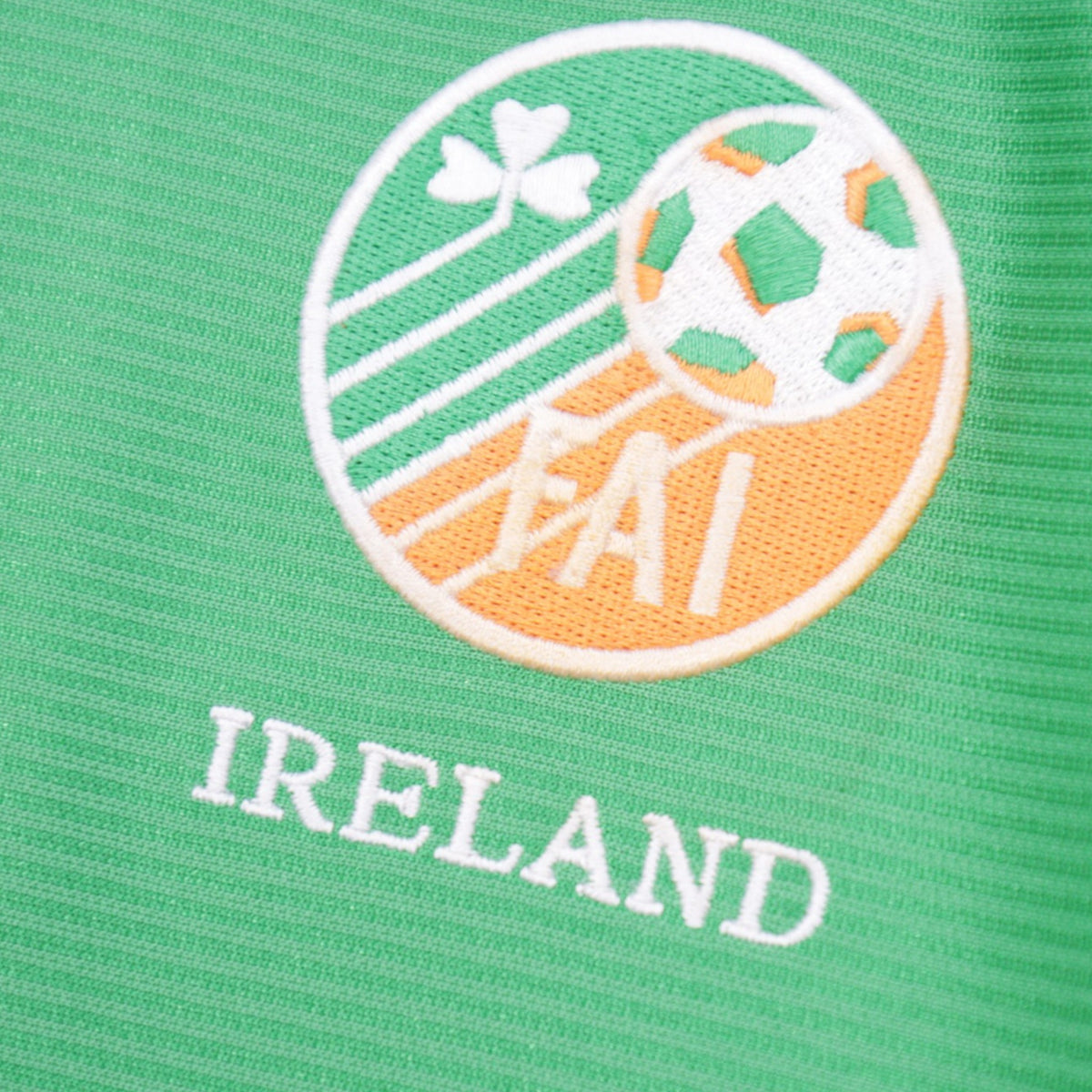 Close-up of embroidered FAI crest and 'IRELAND' text on shirt