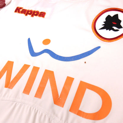 Close-up of Kappa logo, Wind sponsor and Roma crest on the chest