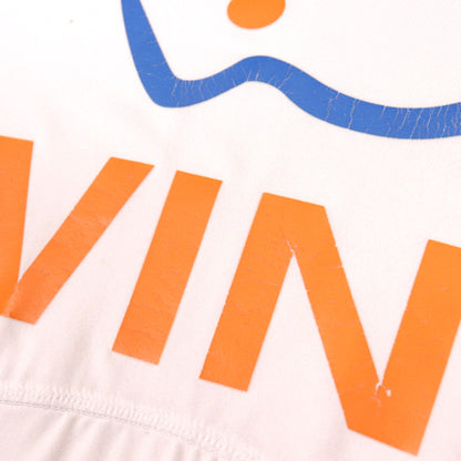 Close-up of the Wind sponsor print showing surface cracking