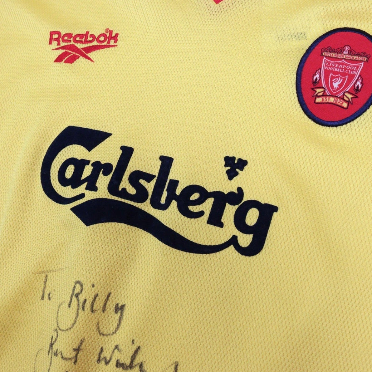 Close-up of Reebok logo, Carlsberg sponsor and Liverpool crest on the chest