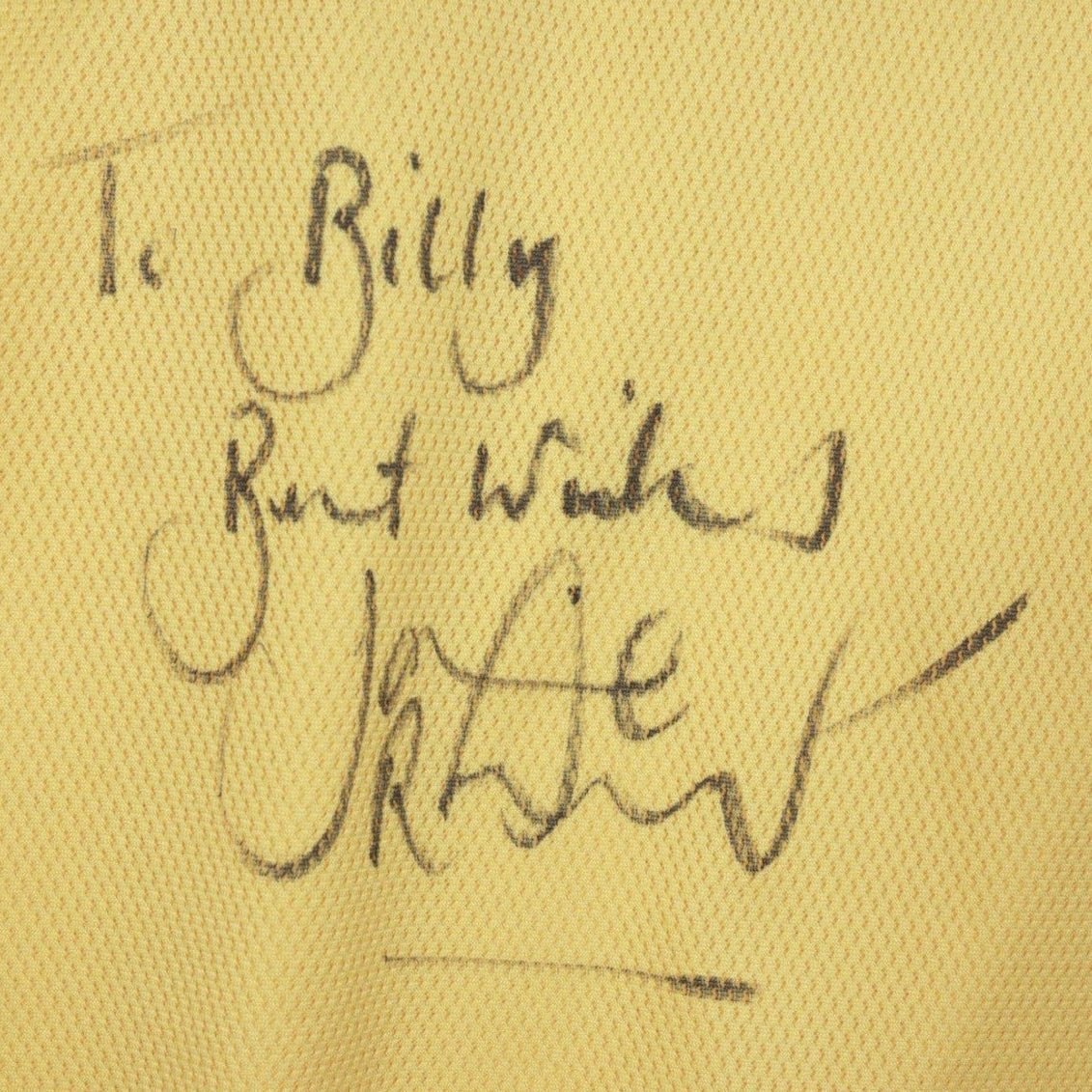 Handwritten dedication and signature on the chest of the shirt