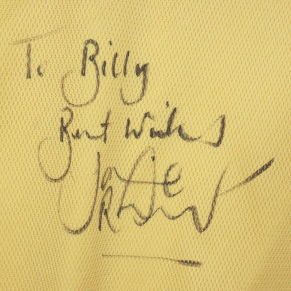 Handwritten dedication and signature on the chest of the shirt