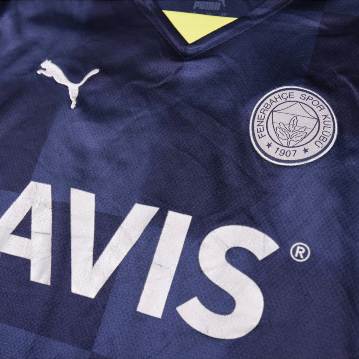Close-up of Fenerbahçe crest and Puma logo on the shirt front