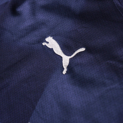 Close-up of the Puma logo embroidery on the shirt