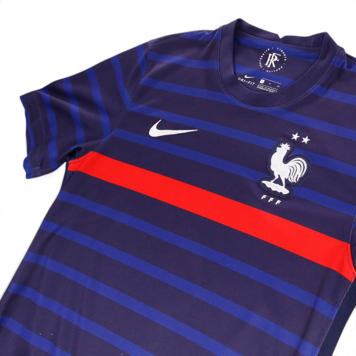 Close-up of Nike swoosh, FFF crest and collar on France home shirt