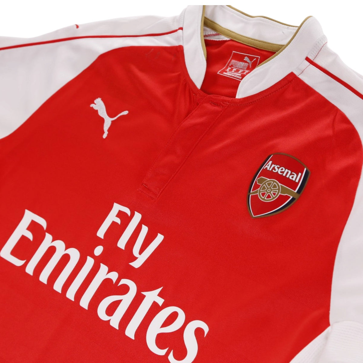 Close-up of Arsenal crest, Puma logo and Fly Emirates sponsor on chest