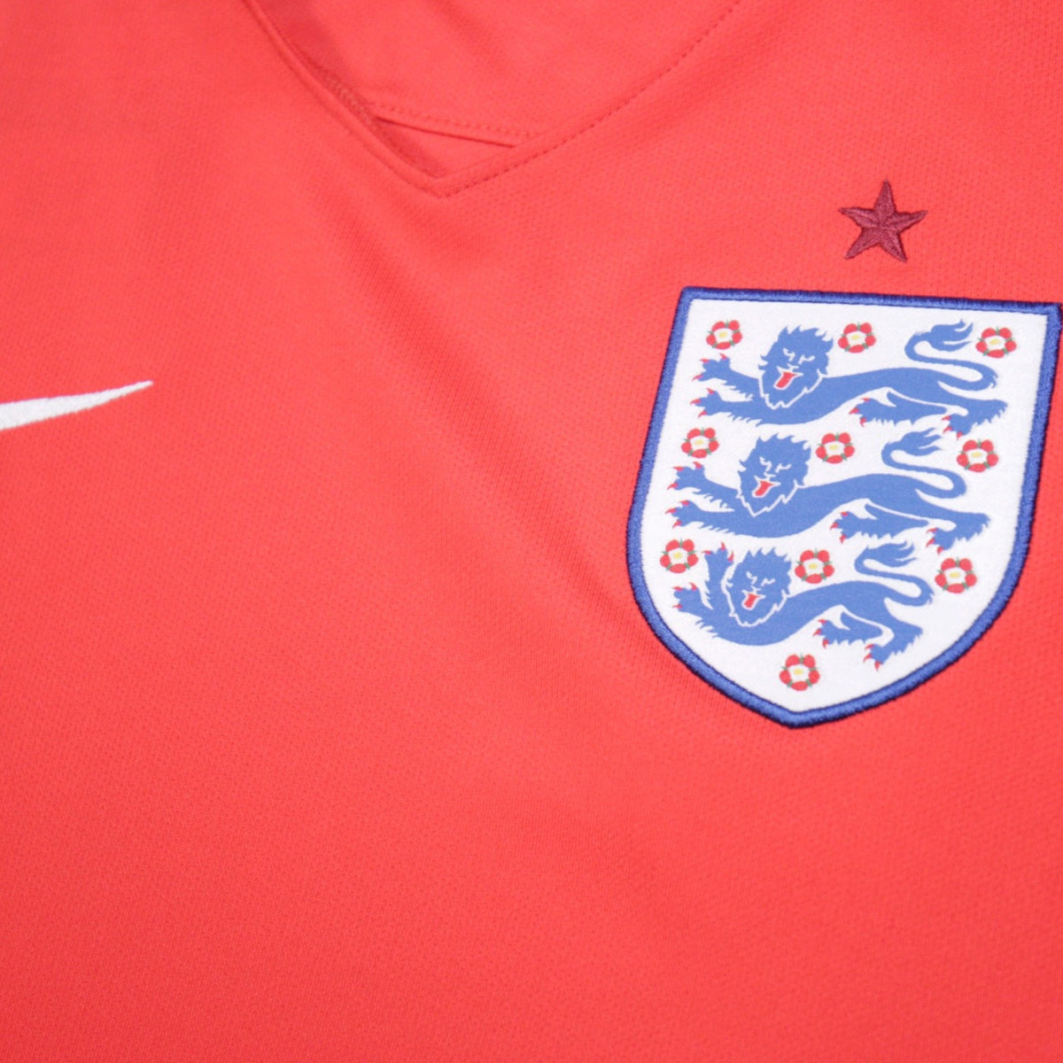 Close-up of FA three lions crest and Nike swoosh on England away shirt