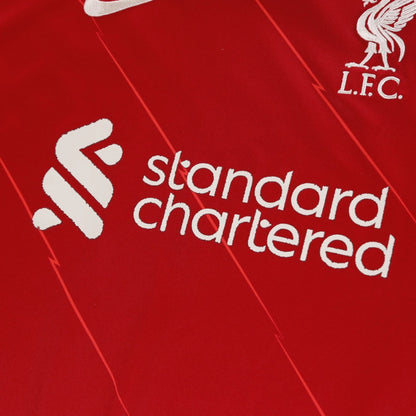 Close-up of Standard Chartered sponsor and Liverpool FC crest on the shirt