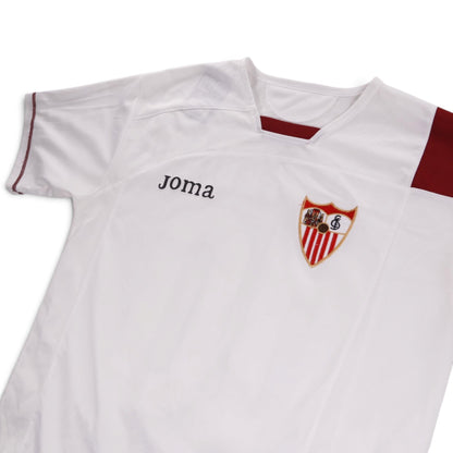 Close-up of the Joma logo and Sevilla crest on the chest