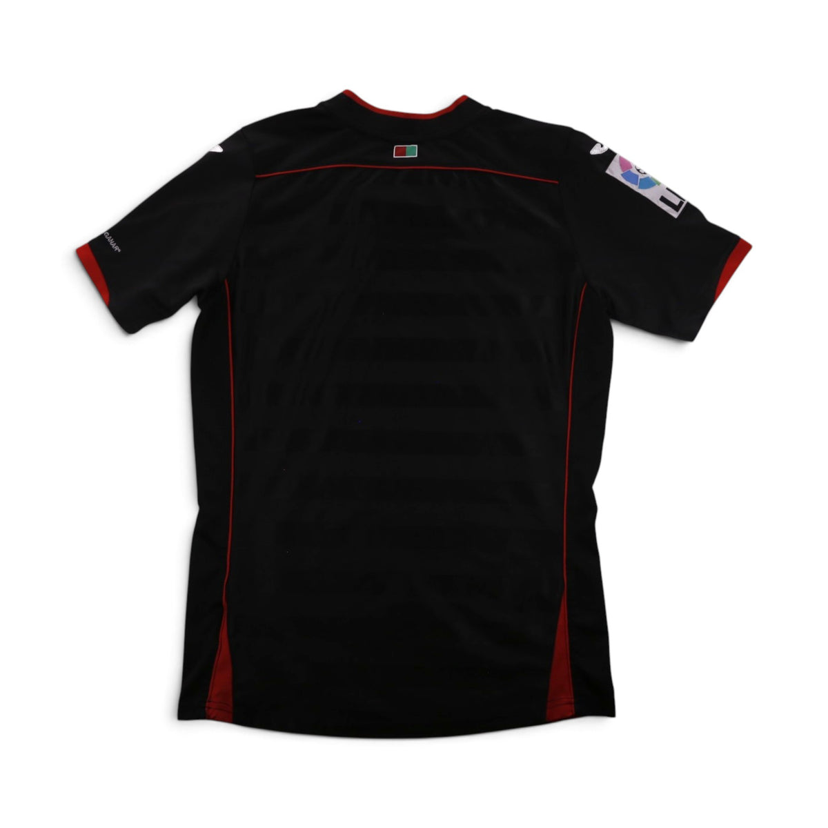 Close-up of the Granada CF crest and Joma logo on the chest