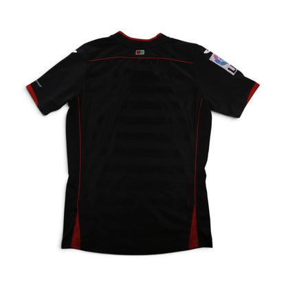 Close-up of the Granada CF crest and Joma logo on the chest