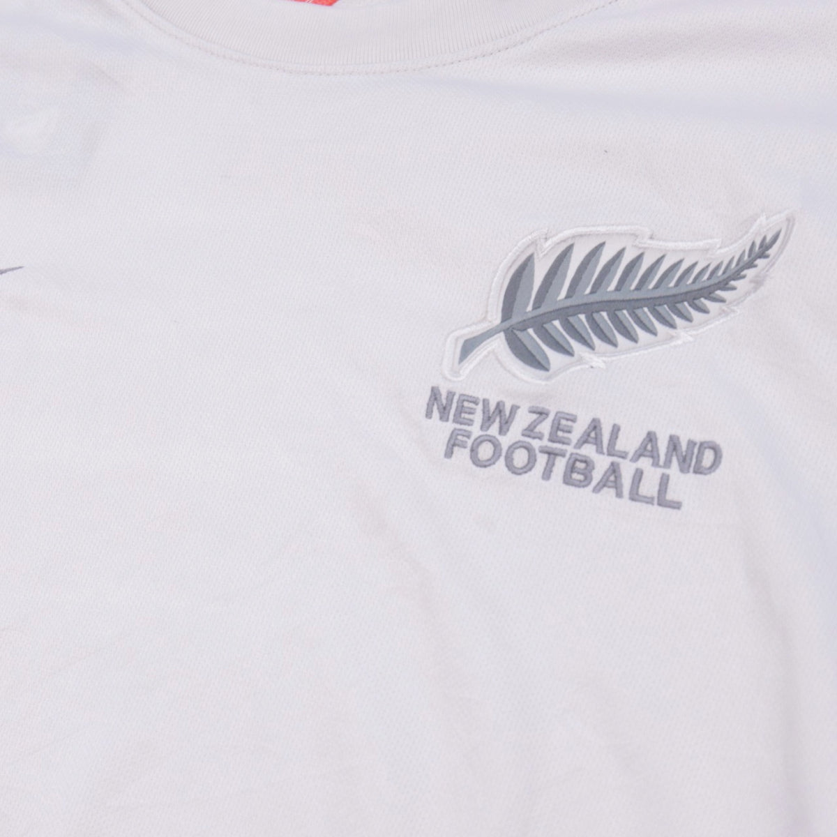 Close-up of New Zealand Football crest and wordmark on chest