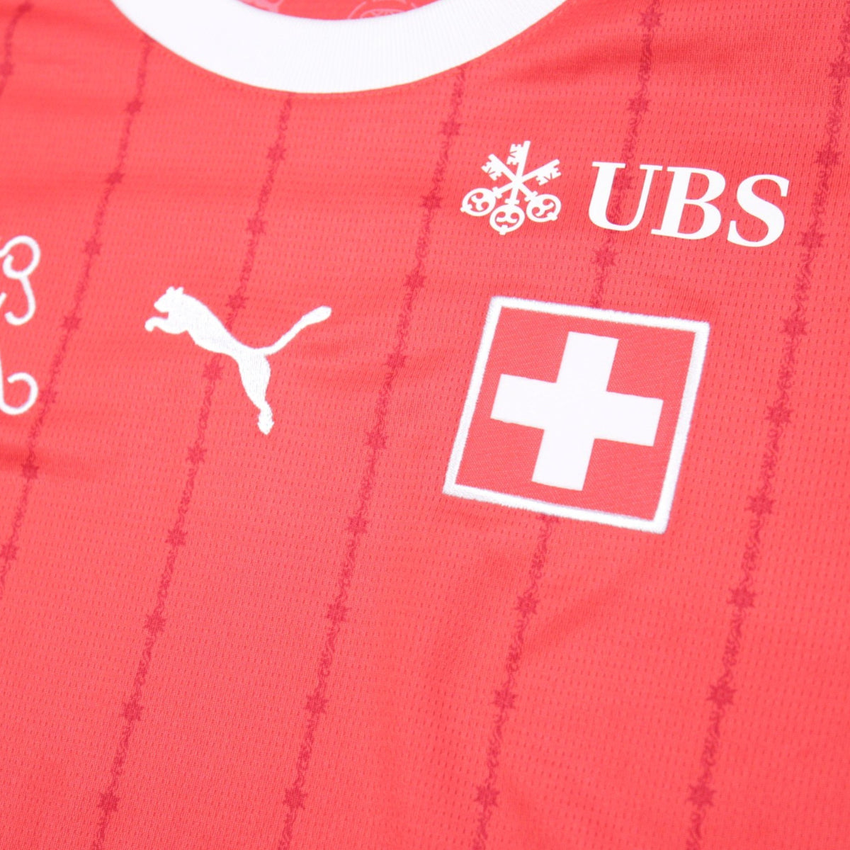 Close-up of Swiss cross crest and UBS sponsor logo on Switzerland home shirt