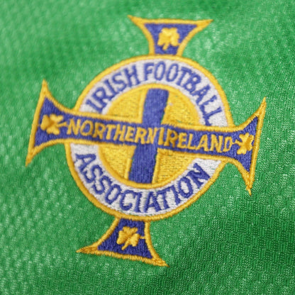 Close-up of the embroidered Irish Football Association crest on the Northern Ireland home shirt