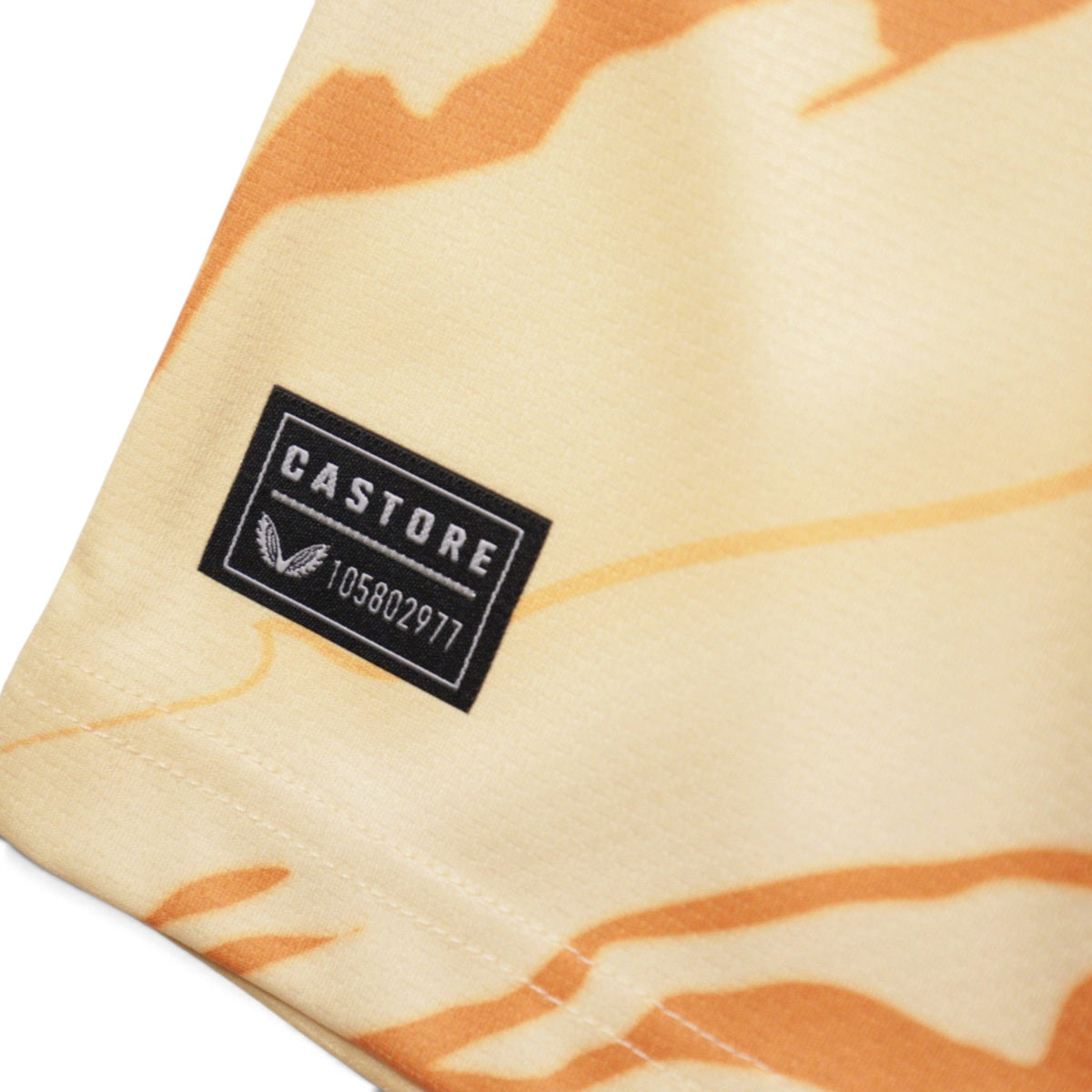 Close-up of Castore manufacturer label and numbered tag on shirt hem